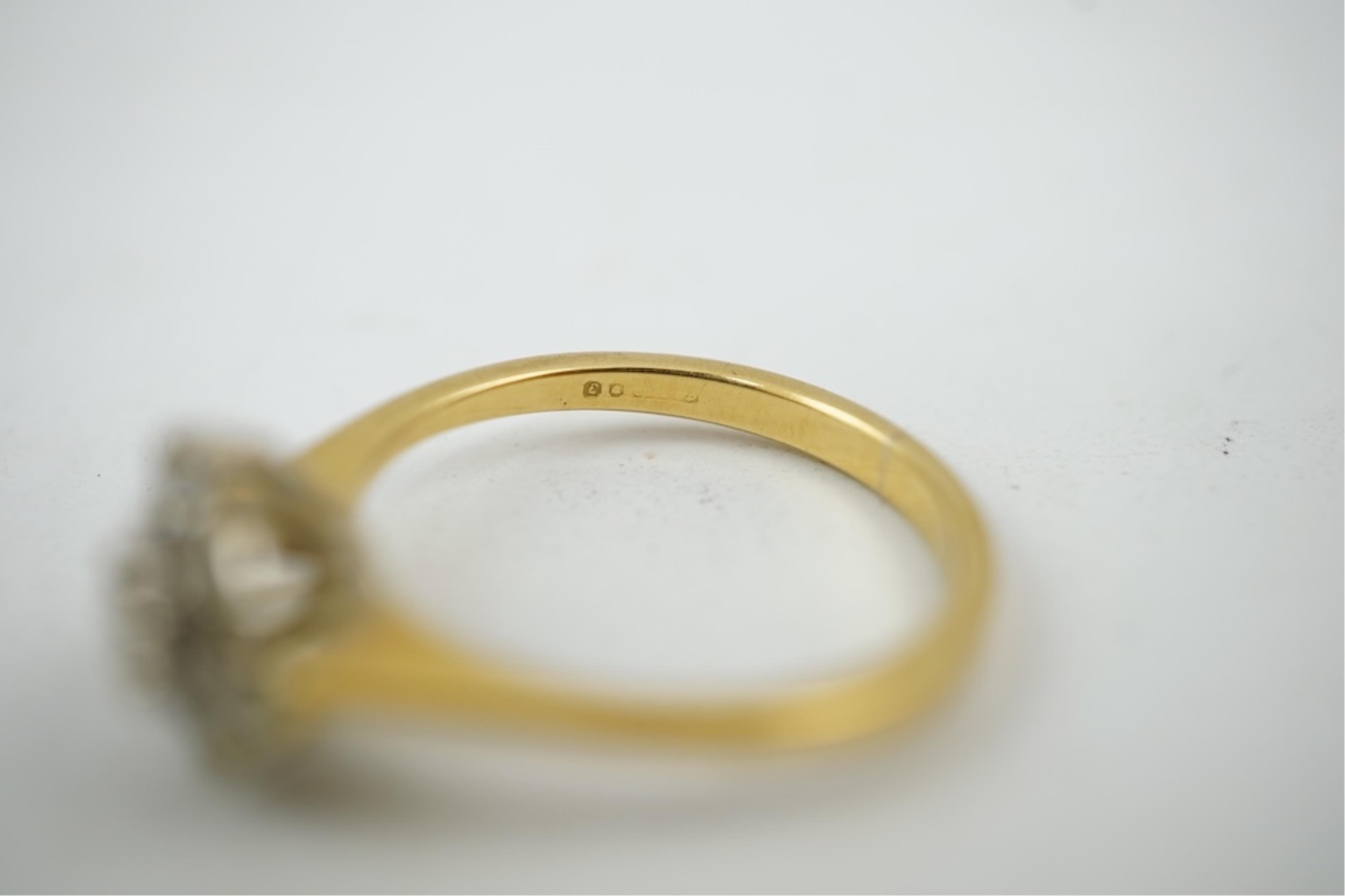 A modern 18ct gold and diamond set circular cluster ring, size M, gross weight 3.2 grams.